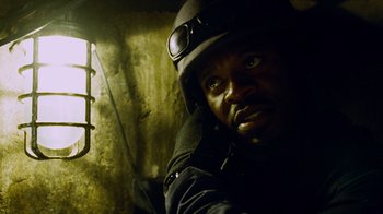 Movie still from “Saw IV” (2007), directed by Darren Lynn Bousman – A man wearing a helmet and a black jacket; Close Up shot, Low angle