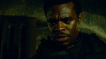 Movie still from “Saw IV” (2007), directed by Darren Lynn Bousman – A man with a beard is looking down at his face; Close Up shot, Low angle