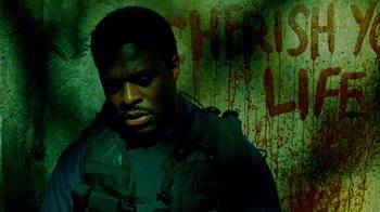 Movie still from “Saw IV” (2007), directed by Darren Lynn Bousman – A man in a black jacket and a blood covered wall; Close Up shot, Low angle