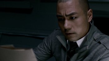 Movie still from “Saw IV” (2007), directed by Darren Lynn Bousman – A person wearing a suit and tie; Close Up shot, High angle