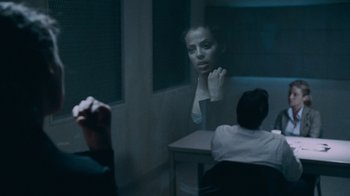 Movie still from “Saw IV” (2007), directed by Darren Lynn Bousman – A woman sitting in front of a mirror in a dark room; Medium shot, Over the shoulder angle