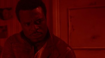 Movie still from “Saw IV” (2007), directed by Darren Lynn Bousman – A person wearing a leather jacket; Close Up shot, Over the shoulder angle