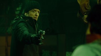 Movie still from “Saw IV” (2007), directed by Darren Lynn Bousman – A man holding a gun while standing in a dark room; Close Up shot, Over the shoulder angle