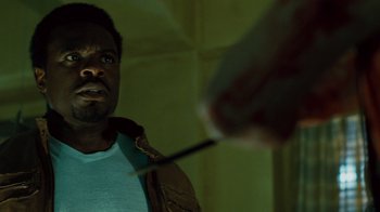 Movie still from “Saw IV” (2007), directed by Darren Lynn Bousman – A man holding a knife in front of a mirror; Close Up shot, Over the shoulder angle