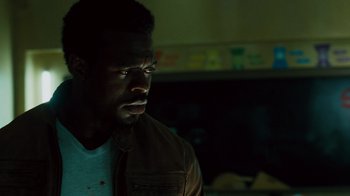 Movie still from “Saw IV” (2007), directed by Darren Lynn Bousman – A person wearing a brown jacket; Close Up shot, Low angle