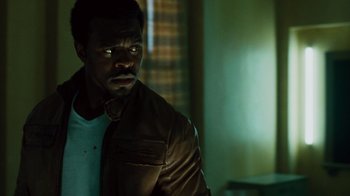 Movie still from “Saw IV” (2007), directed by Darren Lynn Bousman – A man in a leather jacket is looking into the distance; Close Up shot, Low angle