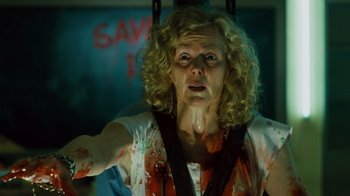 Movie still from “Saw IV” (2007), directed by Darren Lynn Bousman – A woman in a white shirt with blood all over her body; Medium shot, Low angle