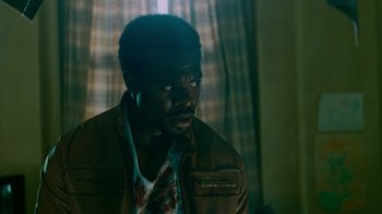 Movie still from “Saw IV” (2007), directed by Darren Lynn Bousman – A man in a brown leather jacket looking to his left; Close Up shot, Low angle