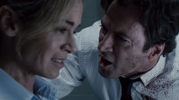 Movie still from “Saw IV” (2007), directed by Darren Lynn Bousman – A man and a woman face each other with blood coming from their mouths; Close Up shot, Over the shoulder angle