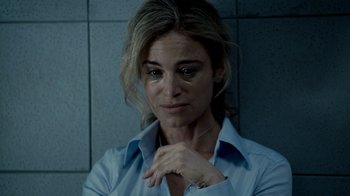 Movie still from “Saw IV” (2007), directed by Darren Lynn Bousman – A woman in a blue shirt is looking at the camera; Close Up shot, Over the shoulder angle