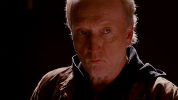 Movie still from “Saw IV” (2007), directed by Darren Lynn Bousman – An older man with a goatee looking at the camera; Close Up shot, Low angle