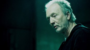 Movie still from “Saw IV” (2007), directed by Darren Lynn Bousman – An older man is looking down at the ground; Close Up shot, Low angle
