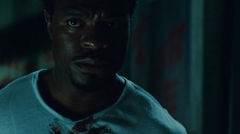 Movie still from “Saw IV” (2007), directed by Darren Lynn Bousman – A person with blood on his face; Close Up shot, Low angle