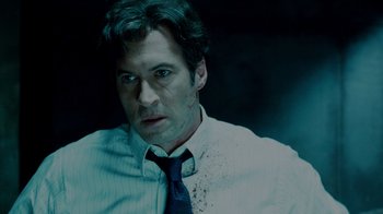 Movie still from “Saw IV” (2007), directed by Darren Lynn Bousman – A person wearing a shirt and a tie; Close Up shot, Low angle