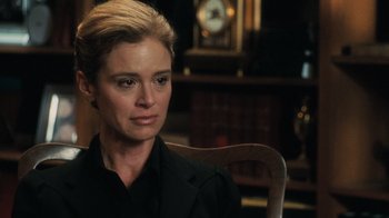 Movie still from “Saw V” (2008), directed by David Hackl – A woman sitting in a chair in front of a clock; Close Up shot, Over the shoulder angle