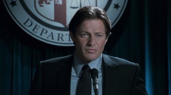 Movie still from “Saw V” (2008), directed by David Hackl – A person wearing a suit and tie; Close Up shot, Low angle