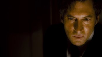 Movie still from “Saw V” (2008), directed by David Hackl – A person in a dark room; Close Up shot, Low angle