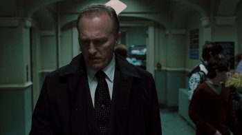 Movie still from “Saw V” (2008), directed by David Hackl – A man in a suit and tie; Close Up shot, Low angle