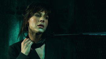 Movie still from “Saw V” (2008), directed by David Hackl – A person wearing a black shirt; Close Up shot, Over the shoulder angle