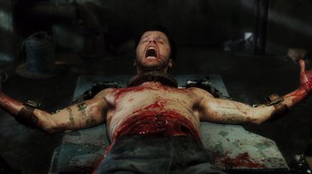 Movie still from “Saw V” (2008), directed by David Hackl – A man with blood all over his face and chest; Medium shot, Overhead angle