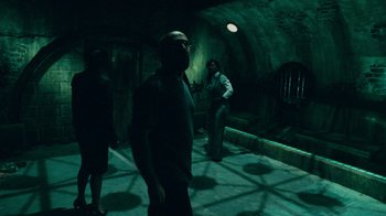 Movie still from “Saw V” (2008), directed by David Hackl – A group of people standing in a dark room; Wide shot, High angle