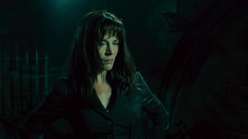 Movie still from “Saw V” (2008), directed by David Hackl – A woman standing in a dark room with her hands on her hips; Close Up shot, Low angle