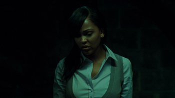 A woman with long black hair wearing a dress shirt and tie