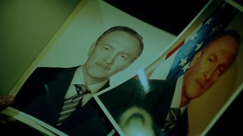 Movie still from “Saw V” (2008), directed by David Hackl – Picture of a man in a business suit; Extreme Close Up shot, Low angle