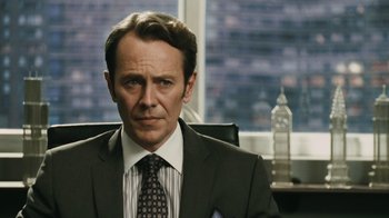 Movie still from “Saw VI” (2009), directed by Kevin Greutert – A man wearing a suit and tie sitting in an office chair; Close Up shot, Over the shoulder angle