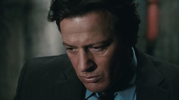 Movie still from “Saw VI” (2009), directed by Kevin Greutert – A person wearing a suit and tie; Close Up shot, Low angle