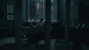 Movie still from “Saw VI” (2009), directed by Kevin Greutert – A man sitting in front of a window in a dark room; Wide shot, High angle