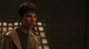 Movie still from “Saw VI” (2009), directed by Kevin Greutert – A man standing in front of a brick wall; Close Up shot, Over the shoulder angle