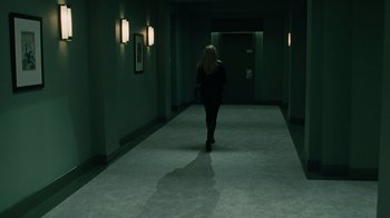 Movie still from “Saw VI” (2009), directed by Kevin Greutert – A woman walking down a hallway in a building; Wide shot, High angle