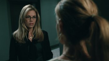 Movie still from “Saw VI” (2009), directed by Kevin Greutert – A woman wearing glasses looking in the mirror; Close Up shot, Over the shoulder angle