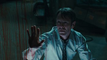 Movie still from “Saw VI” (2009), directed by Kevin Greutert – A man in a white dress shirt and a tie; Medium shot, Low angle