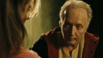 Movie still from “Saw VI” (2009), directed by Kevin Greutert – An older man looking at a young woman in a mirror; Close Up shot, Over the shoulder angle