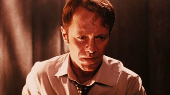Movie still from “Saw VI” (2009), directed by Kevin Greutert – A person wearing a shirt and a tie; Close Up shot, Low angle