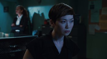 Movie still from “Saw VI” (2009), directed by Kevin Greutert – A woman with short brown hair sitting in a chair; Close Up shot, Over the shoulder angle