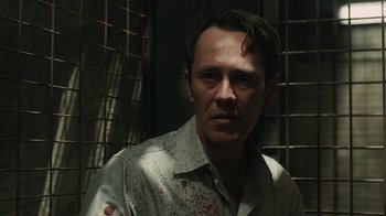 Movie still from “Saw VI” (2009), directed by Kevin Greutert – A person with blood on his face; Close Up shot, Over the shoulder angle