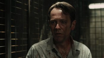 Movie still from “Saw VI” (2009), directed by Kevin Greutert – A person wearing a white shirt; Close Up shot, Over the shoulder angle