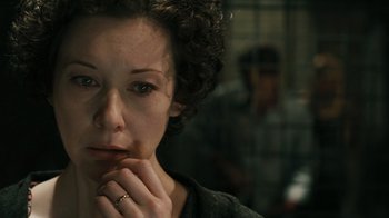 Movie still from “Saw VI” (2009), directed by Kevin Greutert – A person with her hand on her chin; Close Up shot, High angle