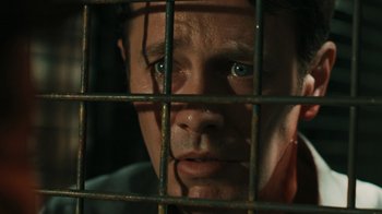 Movie still from “Saw VI” (2009), directed by Kevin Greutert – A person behind a fence; Close Up shot, Overhead angle