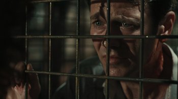 Movie still from “Saw VI” (2009), directed by Kevin Greutert – A man looking through the bars of a jail cell; Close Up shot, High angle