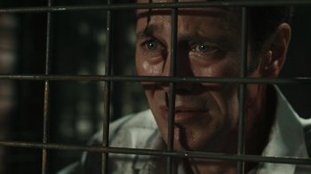 Movie still from “Saw VI” (2009), directed by Kevin Greutert – A person behind a fence; Close Up shot, Low angle