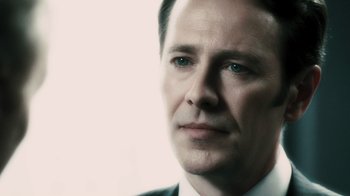 Movie still from “Saw VI” (2009), directed by Kevin Greutert – A person wearing a suit and tie; Close Up shot, Low angle