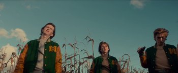 Movie still from “Scary Stories to Tell in the Dark” (2019), directed by André Øvredal – Two young people standing in a field of corn; Medium shot, Low angle