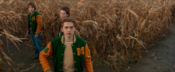 Movie still from “Scary Stories to Tell in the Dark” (2019), directed by André Øvredal – Two young men are walking through a corn field; Medium shot, Low angle