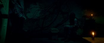 Movie still from “Scary Stories to Tell in the Dark” (2019), directed by André Øvredal – A person standing in a dark room next to a trash can; Wide shot, Low angle
