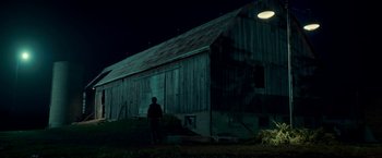 Movie still from “Scary Stories to Tell in the Dark” (2019), directed by André Øvredal – A man standing in front of a barn at night; Extreme Wide shot, Low angle