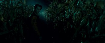 Movie still from “Scary Stories to Tell in the Dark” (2019), directed by André Øvredal – A man standing next to a bunch of trees; Medium shot, High angle